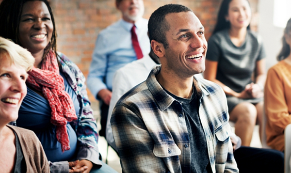 Group of people sitting listening to a presentation