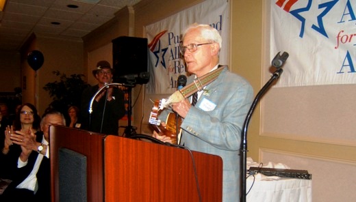 Will Parry playing guitar at his retirement party